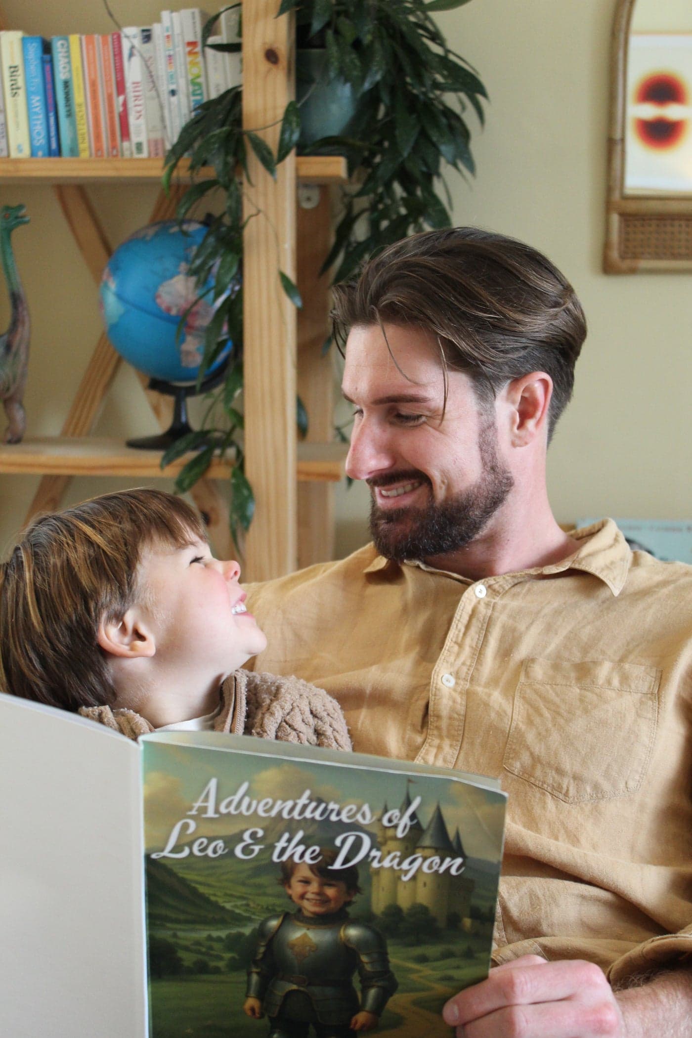 A dad and his son reading his personalised dragon book together